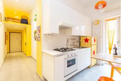 a kitchen with a stove and a refrigerator at Casa Stella in Rome