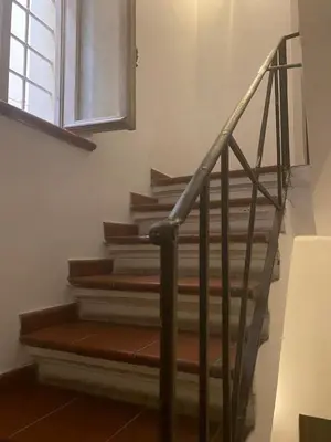 a set of stairs in a room with a window at Harmony in Rome in Rome