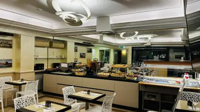 a restaurant with tables and chairs and a counter at Hotel Galileo in Rome