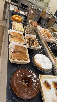 a table with many different types of breads and pastries at Hotel Galileo in Rome