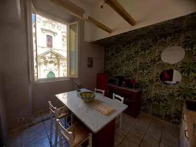 a kitchen with a table and chairs and a window at NEW! BELLISSIMO PalazzoFranchi Pantheon in Rome