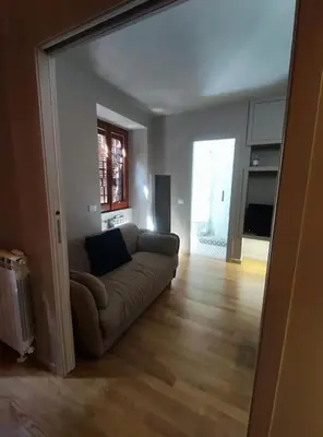 a living room with a couch and a large mirror at 150 m dal Colosseo - Appartamento Minerva in Rome