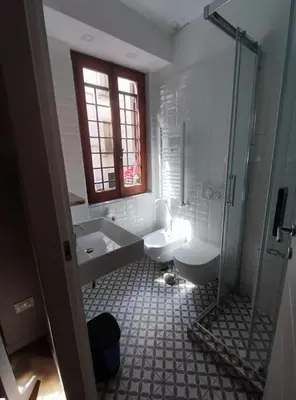 a bathroom with a shower and a toilet and a sink at 150 m dal Colosseo - Appartamento Minerva in Rome