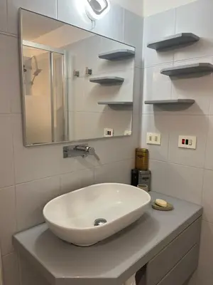 a bathroom with a white sink and a mirror at Vatican near Sweet Home Terrace in Rome