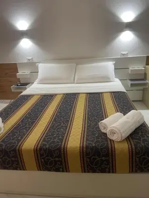 a large bed with two towels on top of it at Roma Palace in Rome