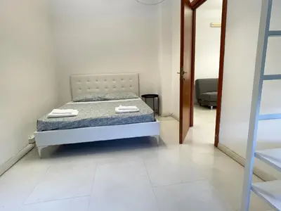 a bedroom with a bed with two towels on it at Mazzini Boutique Apartment in Rome