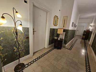 a hallway with a lamp in the middle of a room at 4rooms In Rome in Rome