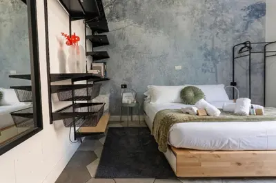 a bedroom with a bed and a yellow chair at Apartment in front of Vatican Museums and Vatican area - myDen in Rome in Rome