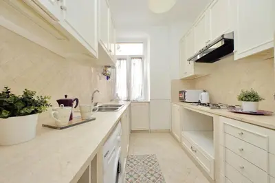 a kitchen with white cabinets and a counter top at Sanctuary Home 32 in Rome