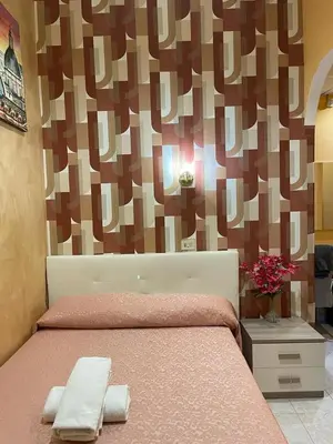 a bed with two towels on it in a bedroom at Mille Guest HOUSE in Rome