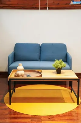 a living room with a blue couch and a coffee table at babuino terrace in Rome