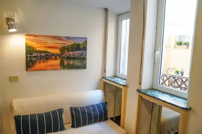 a room with a couch and a painting on the wall at babuino terrace in Rome