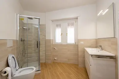 a bathroom with a shower and a toilet and a sink at Jmartins Vatican 2 in Rome