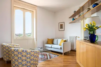 a living room with a couch and a chair at Refined upper-level apartment - Unique View of Rome's Skyline Tibernestrome in Rome