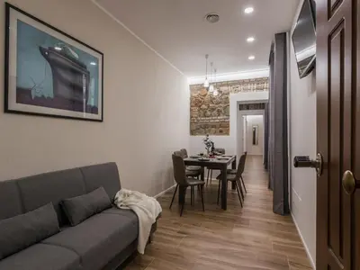 a living room with a couch and a table at The Best Rent - Modern three-bedroom apartment a few steps from the Colosseum in Rome