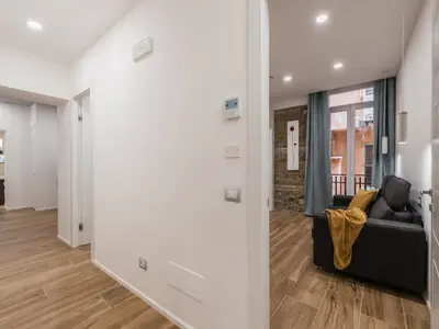a living room with a couch and a table at The Best Rent - Modern three-bedroom apartment a few steps from the Colosseum in Rome
