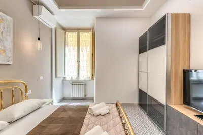 a living room with a tv and a couch at Rhome Colosseum in Rome