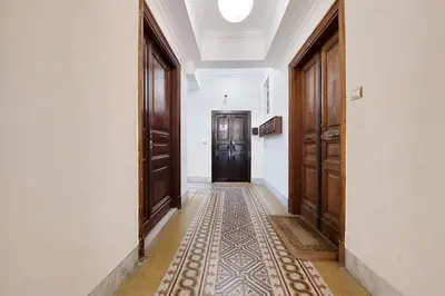 an empty hallway with a door and a rug at Colosseum romantic home in Rome