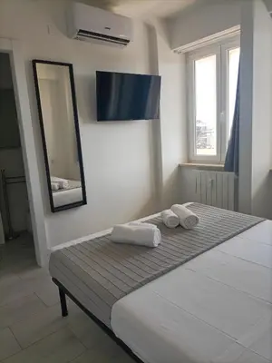 a bedroom with a bed with two towels on it at La Terrazza sull'Appia by Hostand in Rome