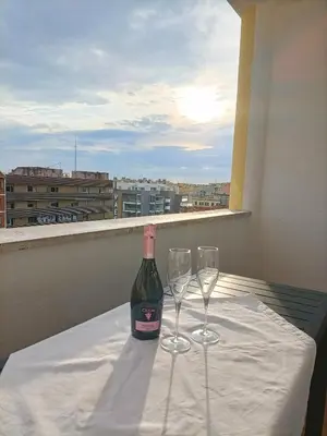 a bottle of wine sitting on a table with two glasses at La Terrazza sull'Appia by Hostand in Rome