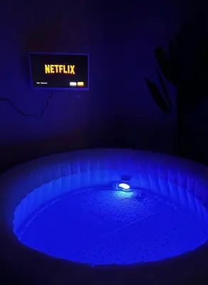 a sign in a dark room with a hot tub at Vita lenta terrazza Roma Garbatella in Rome