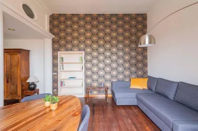 a living room with a blue couch and a table at Colosseum Loft - ZENO 12 in Rome
