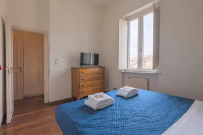 a bedroom with a blue bed with two towels on it at Colosseum Loft - ZENO 12 in Rome