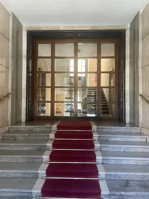 a staircase with a red carpet in front of a building at Residenza Clodio Vatican in Rome