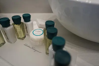 a group of four bottles of essential oils on a counter at Màs Boutique Hotel Rome in Rome