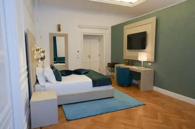 a bedroom with a bed and a television in it at Màs Boutique Hotel Rome in Rome