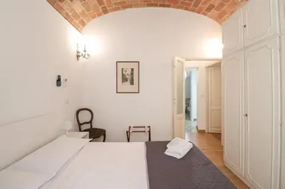 a bedroom with a white bed and a brick ceiling at Casa Cecilia a Monti in Rome
