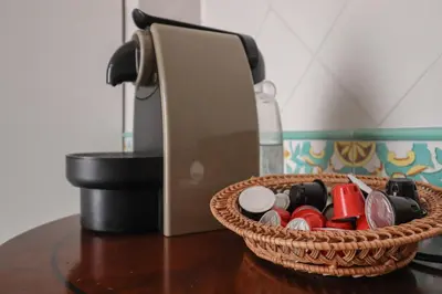 a wicker basket sitting on a table next to a phone at Casa Cecilia a Monti in Rome