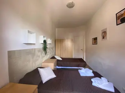 two beds in a room with two beds sidx sidx sidx sidx at The italian House in Rome a pochi passi dalla metro A in Rome