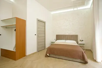 a bedroom with a bed in a white room at Rohome Stay in Rome
