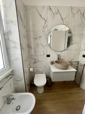 a bathroom with a sink and a toilet and a mirror at Aurelia's Hideaway, Near Vatican in Rome