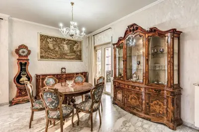 a dining room with a table and chairs and a chandelier at Vacanze romane in Rome