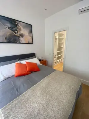 a bedroom with a bed with orange pillows on it at Maison de charme Domus Clodio XIV in Rome