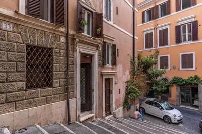 a person sitting next to a car on a street at Ibernesi Luxury Home in Rome