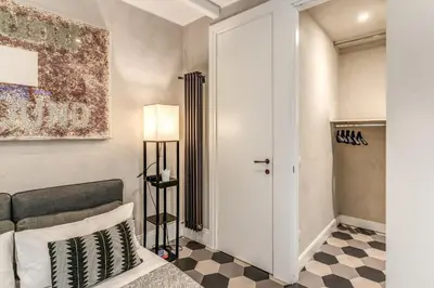 a bedroom with a bed and a checkered floor at Ibernesi Luxury Home in Rome