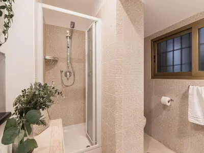 a bathroom with a shower with a glass door at The Best Rent - Two-bedroom apartment in Colosseum area in Rome