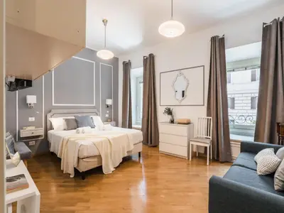 a large bedroom with a bed and a couch at The Best Rent - Two-bedroom apartment in Colosseum area in Rome