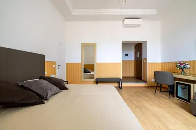 a bedroom with a large bed and a fireplace at La Maison Royale in Rome