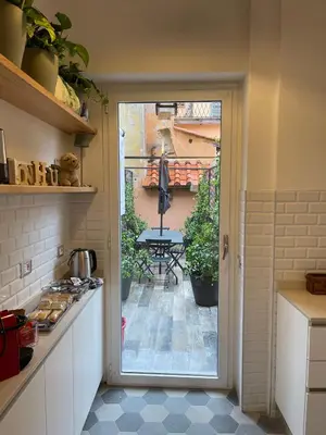a kitchen with a door leading to a patio at THE BREAK - Piazza di Spagna Maison Deluxe Terrace in Rome