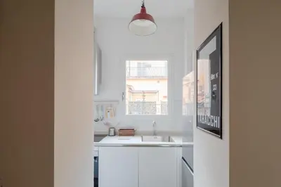 a white kitchen with a sink and a window at THE BREAK - Piazza di Spagna Maison Deluxe Terrace in Rome
