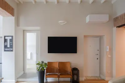 a living room with a flat screen tv on a wall at THE BREAK - Piazza di Spagna Maison Deluxe Terrace in Rome