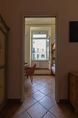 a hallway with a window and a chair in a room at La Dolce Vita - IRIDE's Nest in Rome