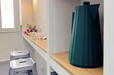 a large green vase sitting on a shelf in a bathroom at YCH-Montebello - Rooms in Rome