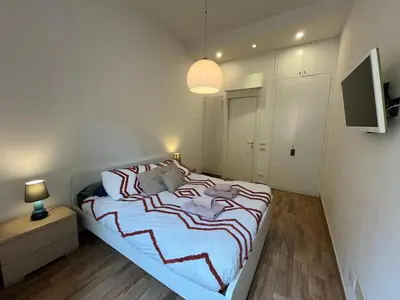a bedroom with a bed and a television in it at La Dolce Vita - Luxury Colosseum Boutique Apartment in Rome