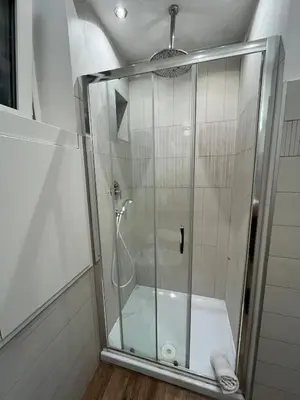 a shower with a glass door in a bathroom at La Dolce Vita - Luxury Colosseum Boutique Apartment in Rome