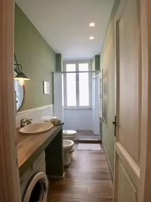 a bathroom with a toilet and a sink and a shower at Roma Testaccio - Volta 45 apartment in Rome
